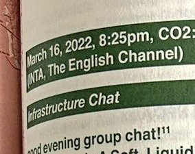 A close-up of a green and white label showing text for an event on March 16, 2022, at 8:25 PM on The English Channel, with the title "Infrastructure Chat" and a note about a group chat.