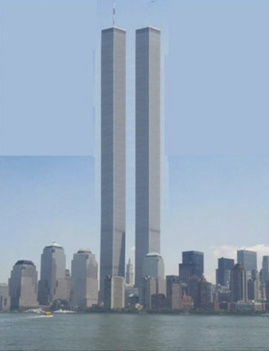 The image shows the Twin Towers of the World Trade Center in New York City, standing tall against a clear blue sky with the city skyline and water in the foreground.