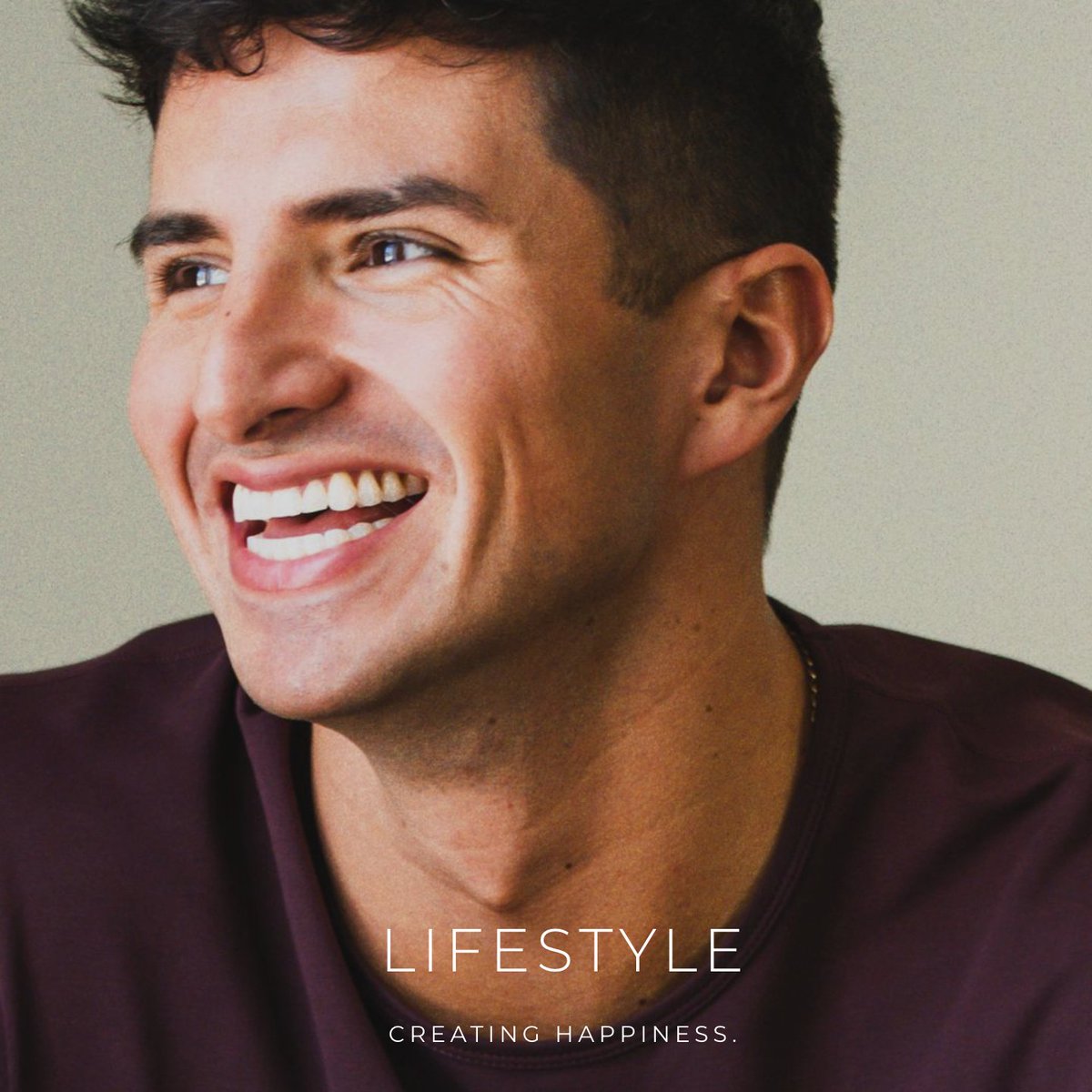 A smiling man with dark hair and a maroon shirt looks upward with a joyful expression, with the text "LIFESTYLE" and "CREATING HAPPINESS." overlaid on the image.